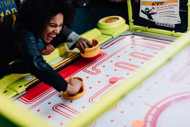Mixed race couples on a day out at seaside having fun.